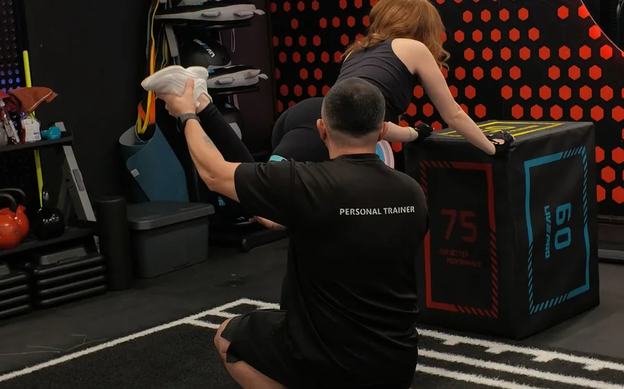 Elevate coach guiding a client at the plyo box