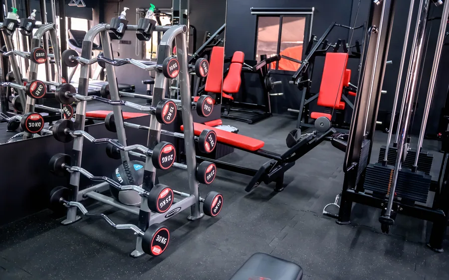 Dumbbell rack and red benches in an Elevate ladies-only studio, Muscat