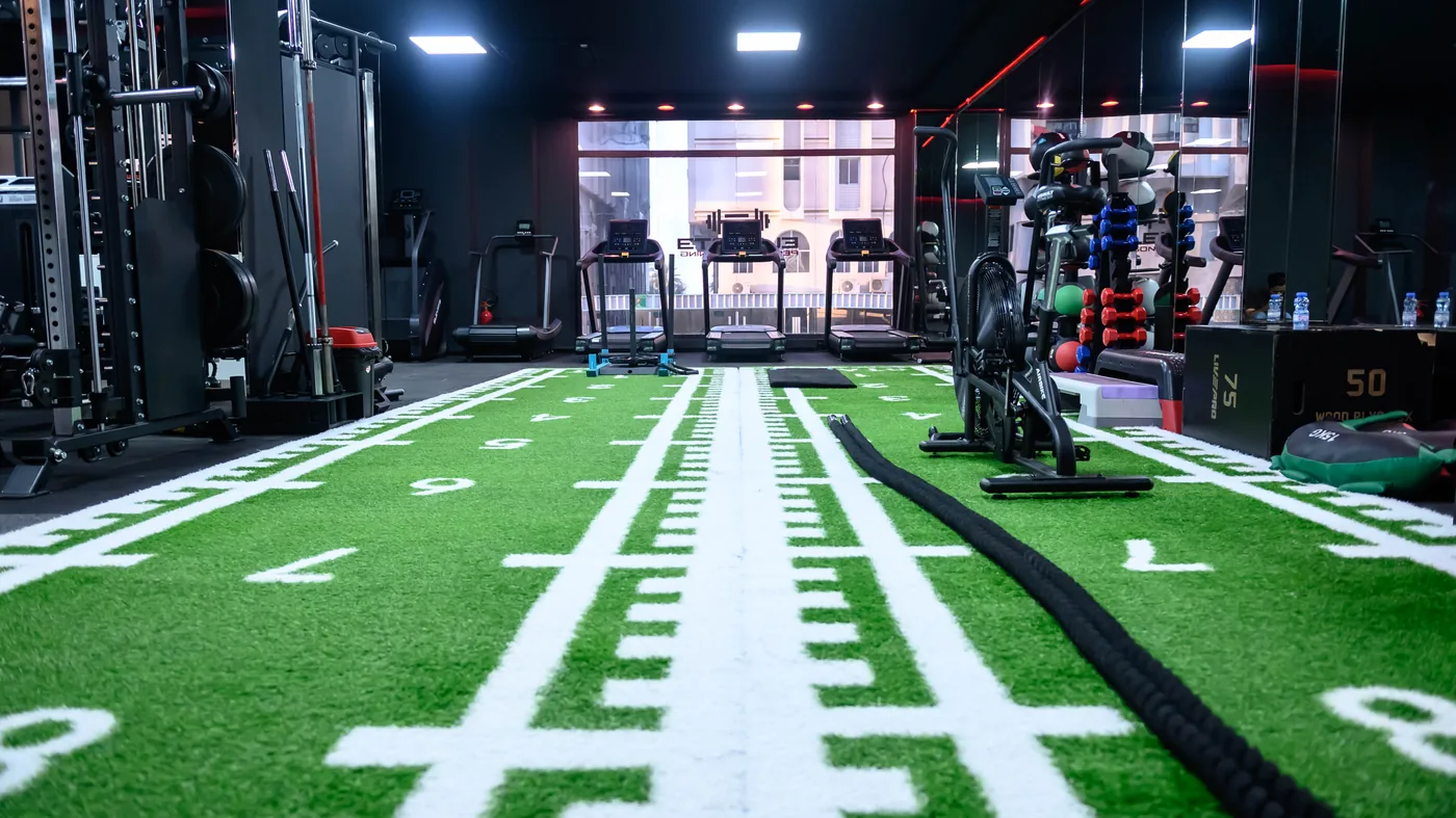 Al Khuwair 2 Elevate gym in Al Khuwair, Muscat — turf sprint lanes, battle rope and air bike leading to the treadmills