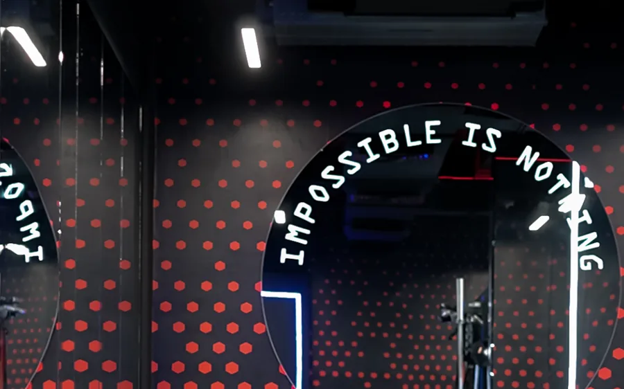 Elevate mixed gym in Azaiba, Muscat &mdash; red hex wall, round mirror and sprint turf inside the private studio